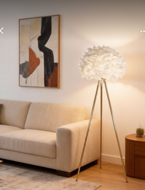 A Decorative Floor Lamp With A Gold Frame And A White Feather Lampshade.